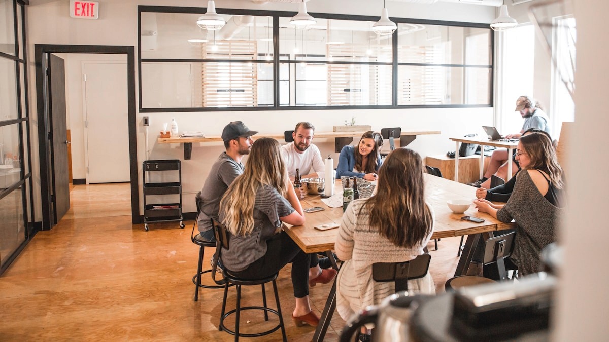 Colleagues collaborating around a table in a bright office